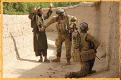 RTF4 Diggers search a local during a patrol in the Baluchi Valley Afghanistan