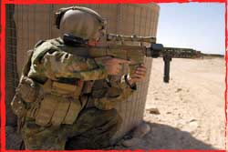 An MTF1 NCO observes through the scope of his Mk11 Mod0 rifle.