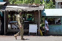 Australian military personnel patrol a market in the Solomon Islands on November 27 2021